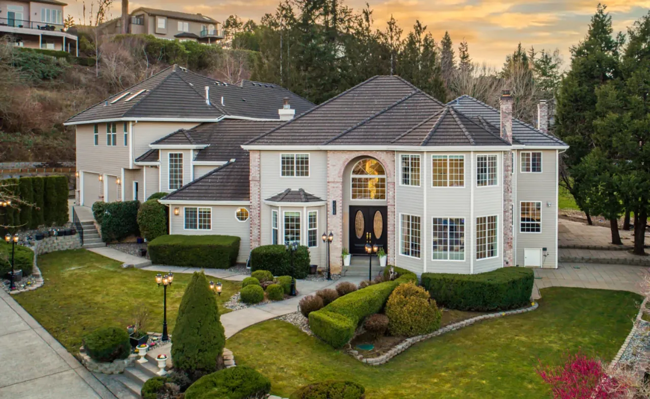 A large residence photographed from an elevated angle in warm evening light