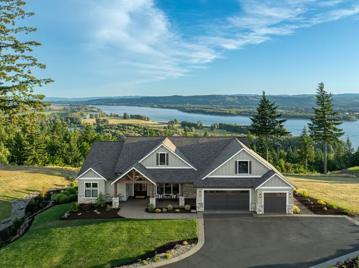 Aerial view of a home in a wooded landscape