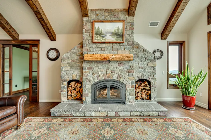 Stone fireplace beneath exposed timber beams
