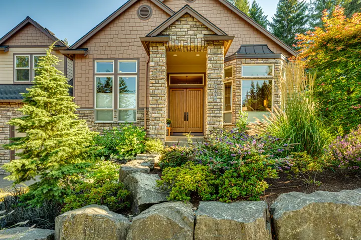 Home entrance with stonework and landscaping