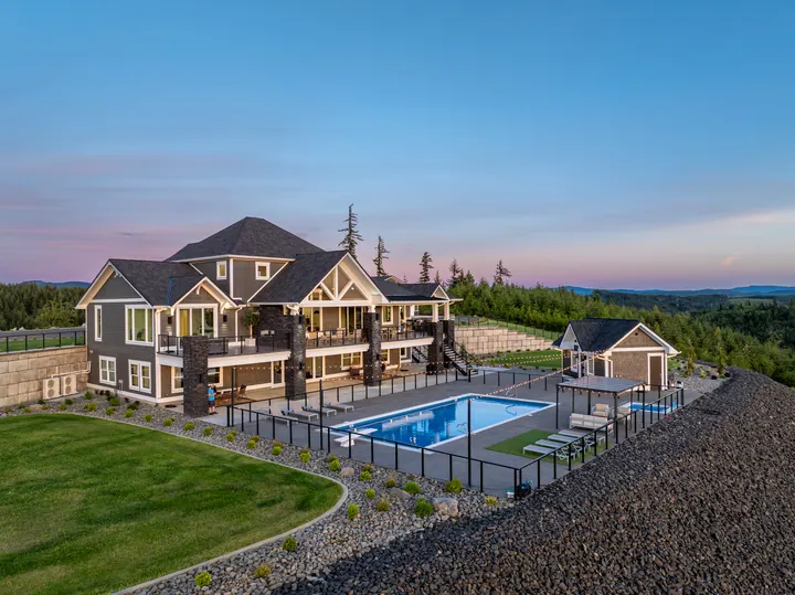 Aerial view of a home and pool at dusk