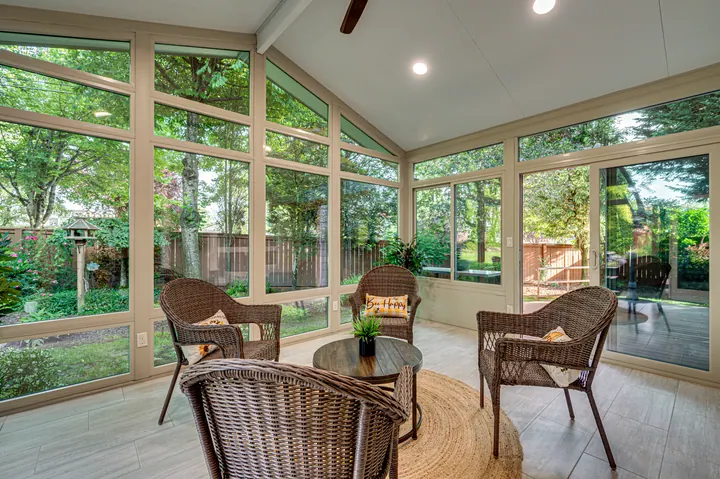 Sunroom with broad windows facing trees
