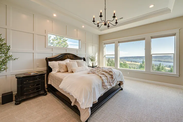 Bedroom with large windows and a distant view