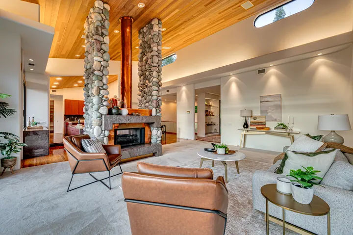 Wood-paneled living room with a stone fireplace