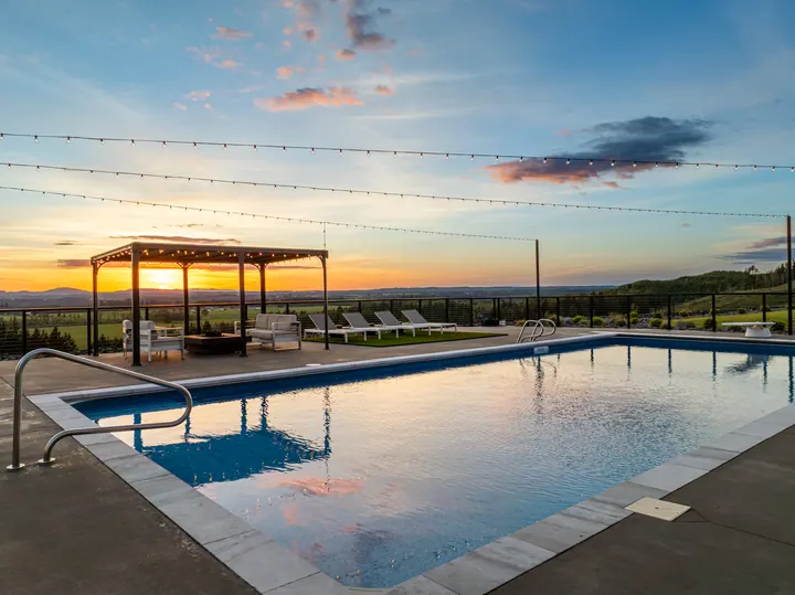 Outdoor pool reflecting the sunset