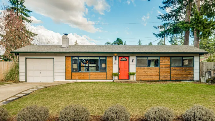 Single-story home with a bright red front door