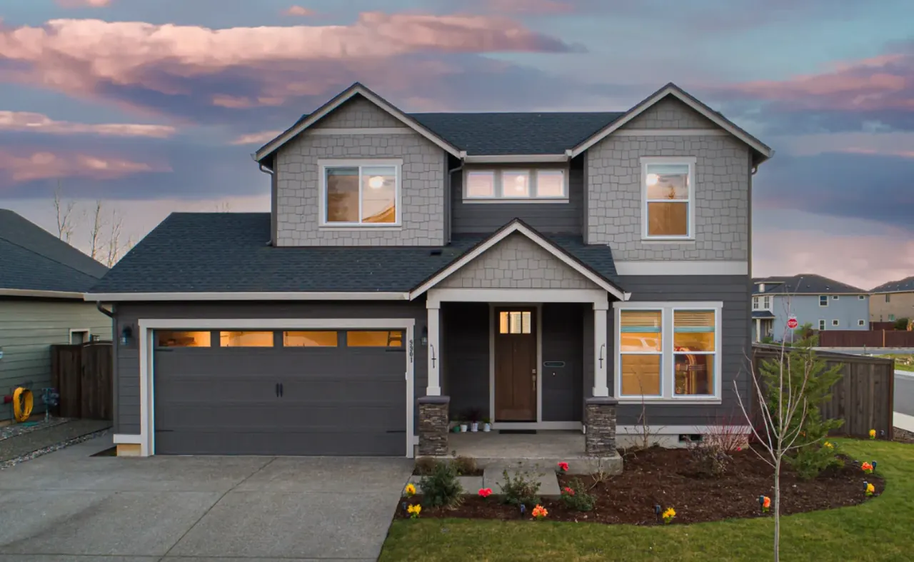 A modern two-story home photographed in soft evening light